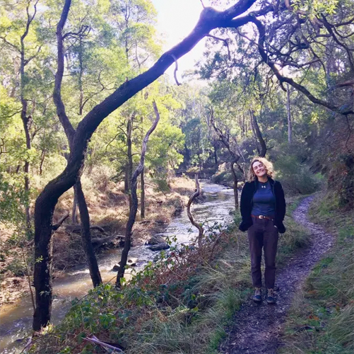 Michaela Bohunicky standing on a footpath next to a stream